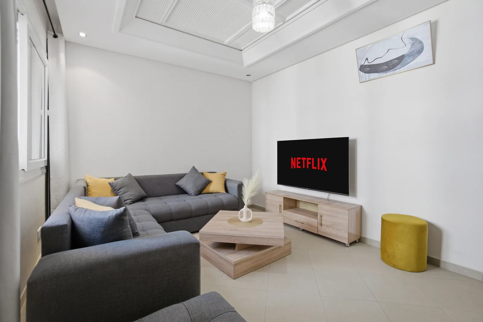 Living room with smart TV and modern corner sofa