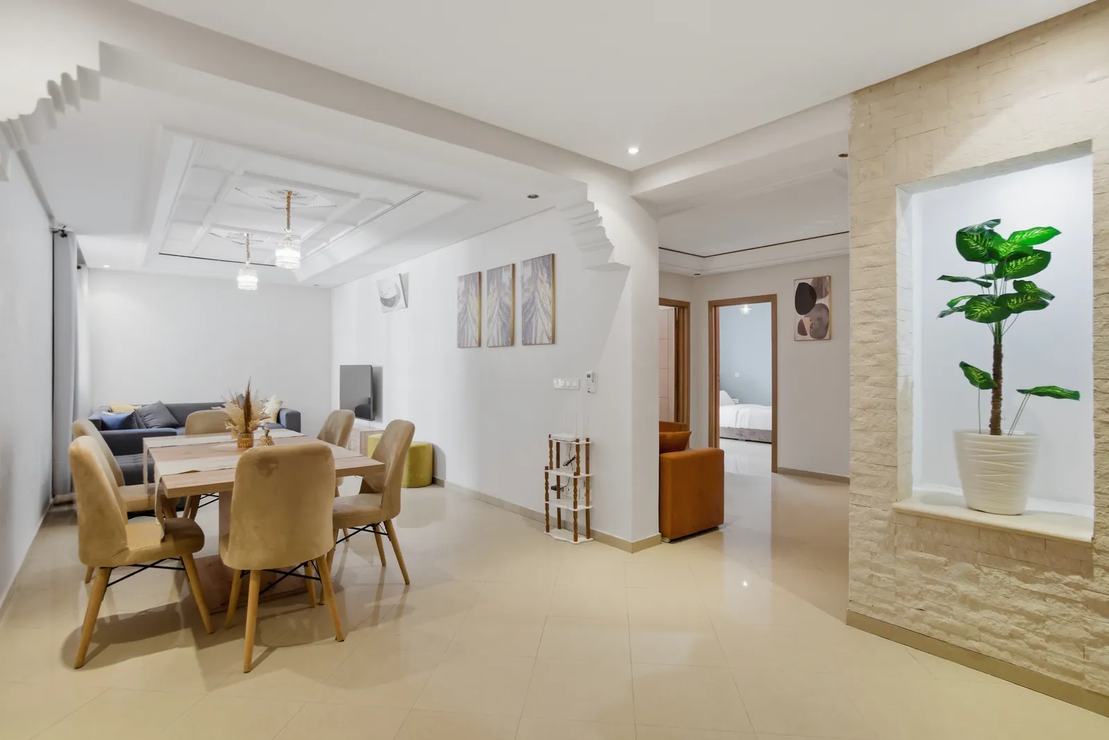 Wide view of living room, dining area and access to bedrooms