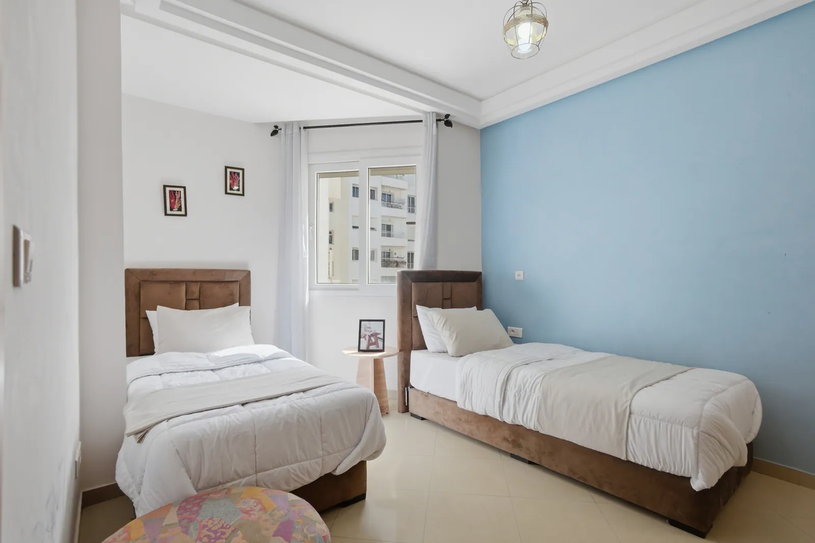 Second bedroom with two single beds and city view